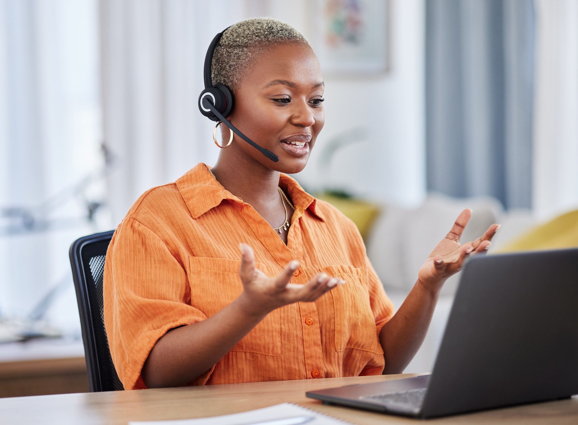 Black woman, call center and consulting on laptop in customer service, support or telemarketing at home. African freelance person or consultant agent talking on computer with headset in online advice